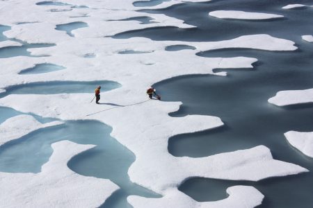 The crew of the u.s. coast guard cutter healy, in the midst of their icescape mission, retrieves supplies dropped by parachute in the arctic ocean