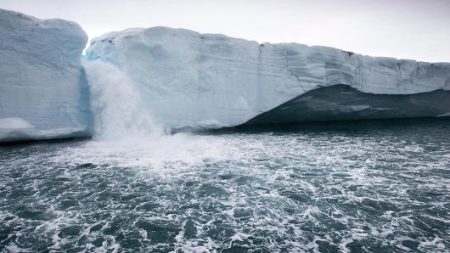 Melting water pours from ice face